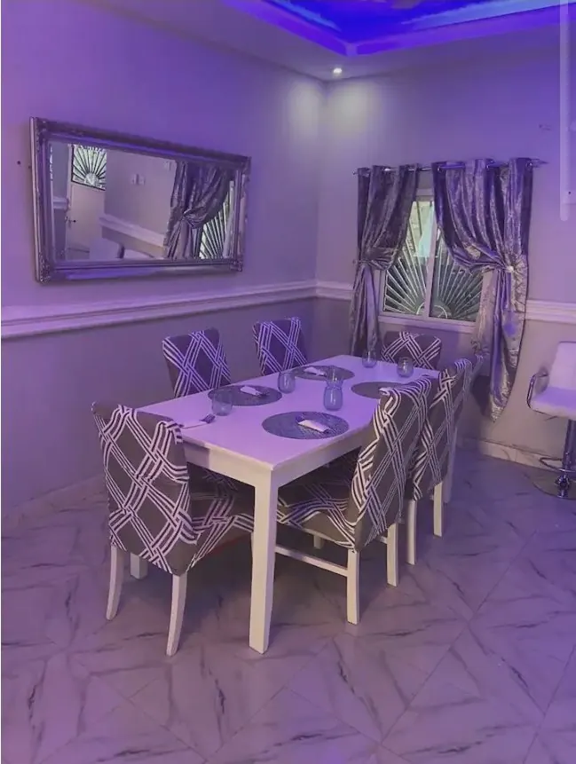 Six-seater dining table under ambient cove lighting